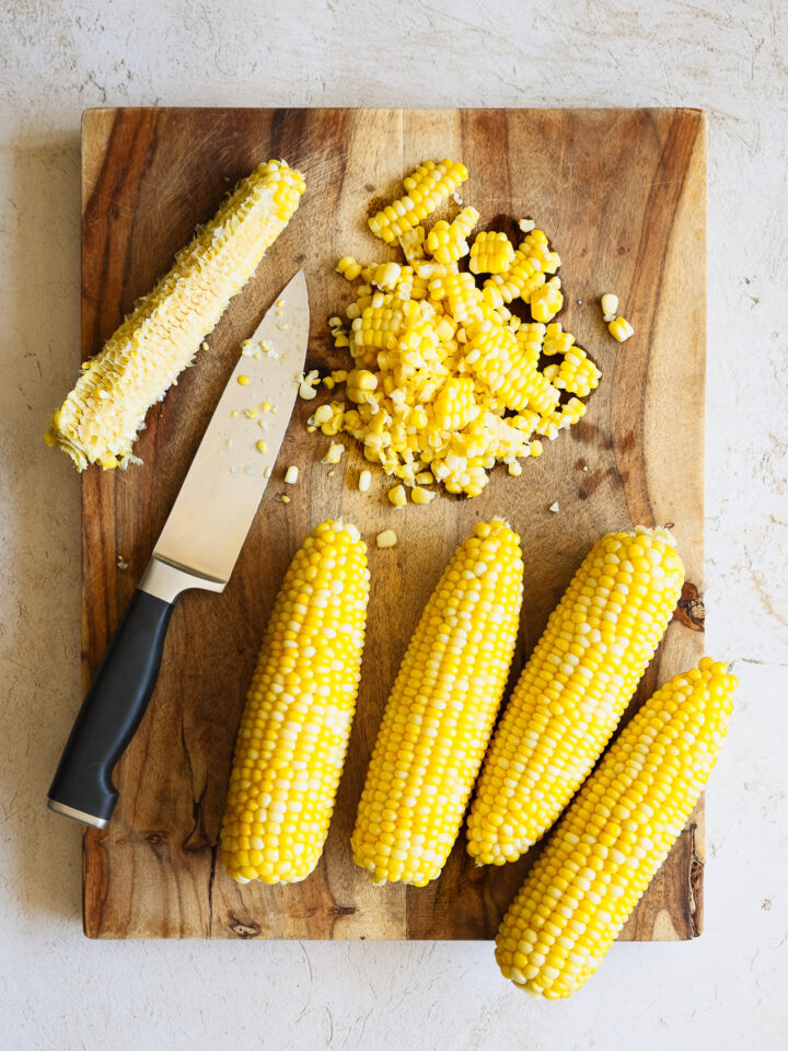 kernels off the cob on a wooden board.