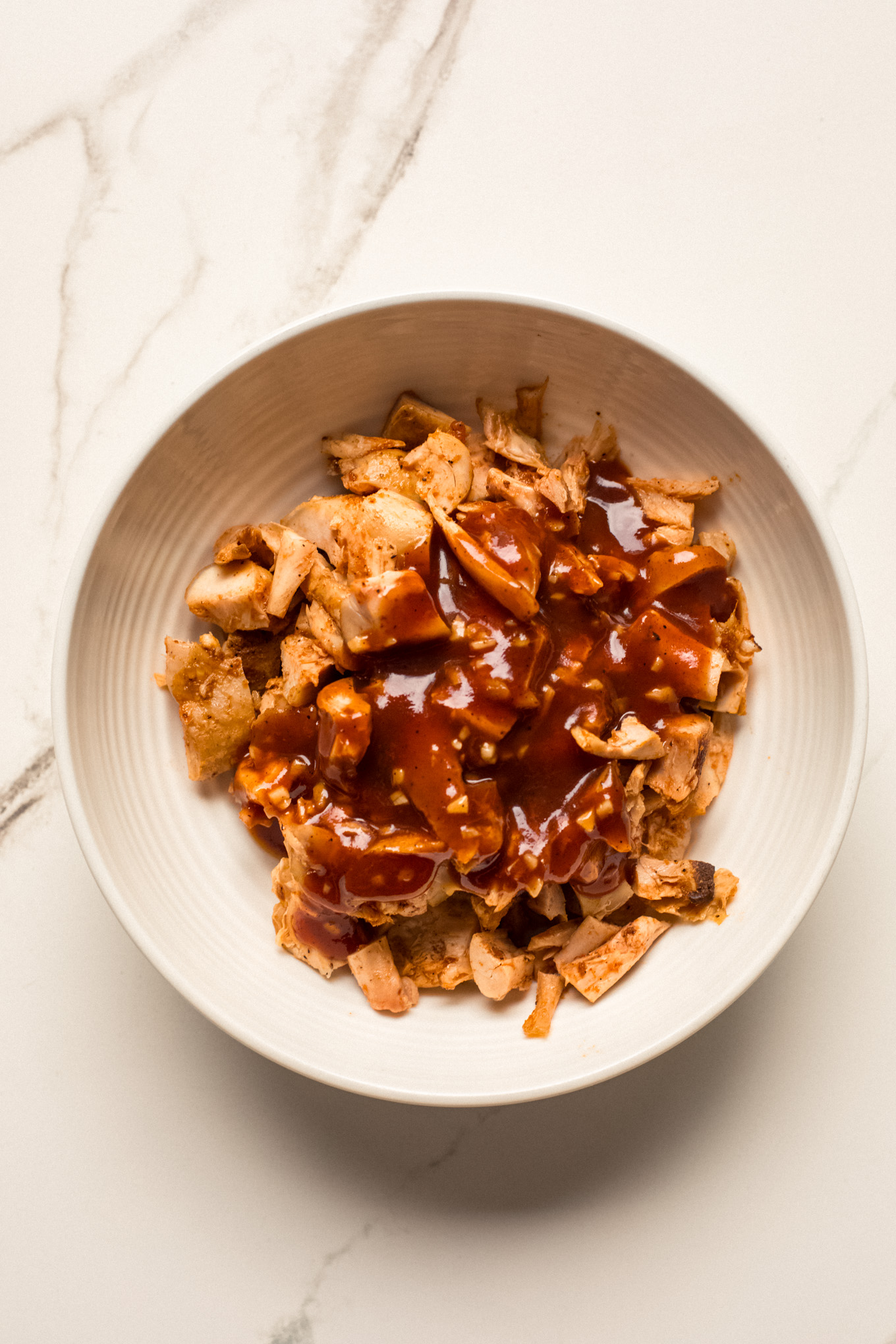 diced cooked chicken covered with bbq sauce.