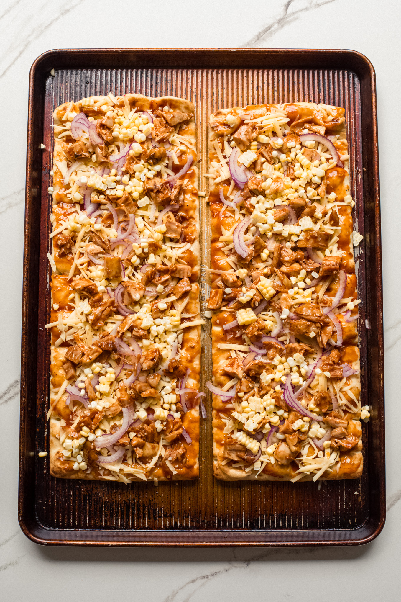 flatbread topped with chicken and cheese.