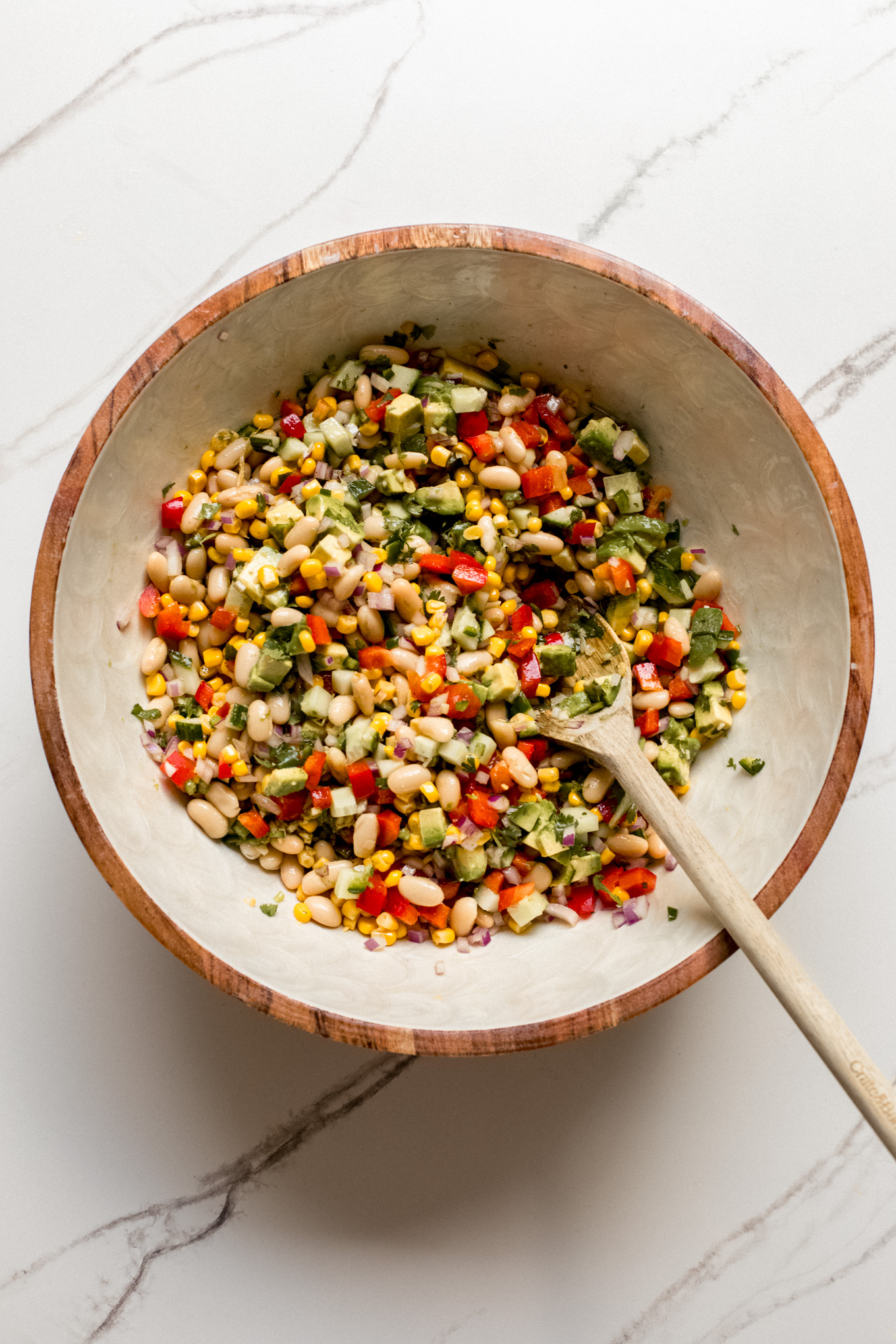 tossed salad with a spoon in a bowl.