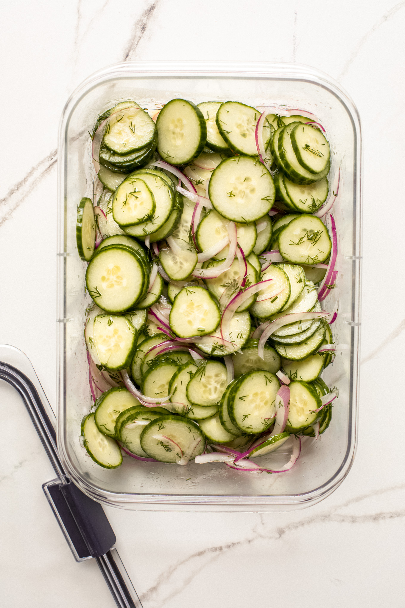 easy cucumber salad in a tupperware container.