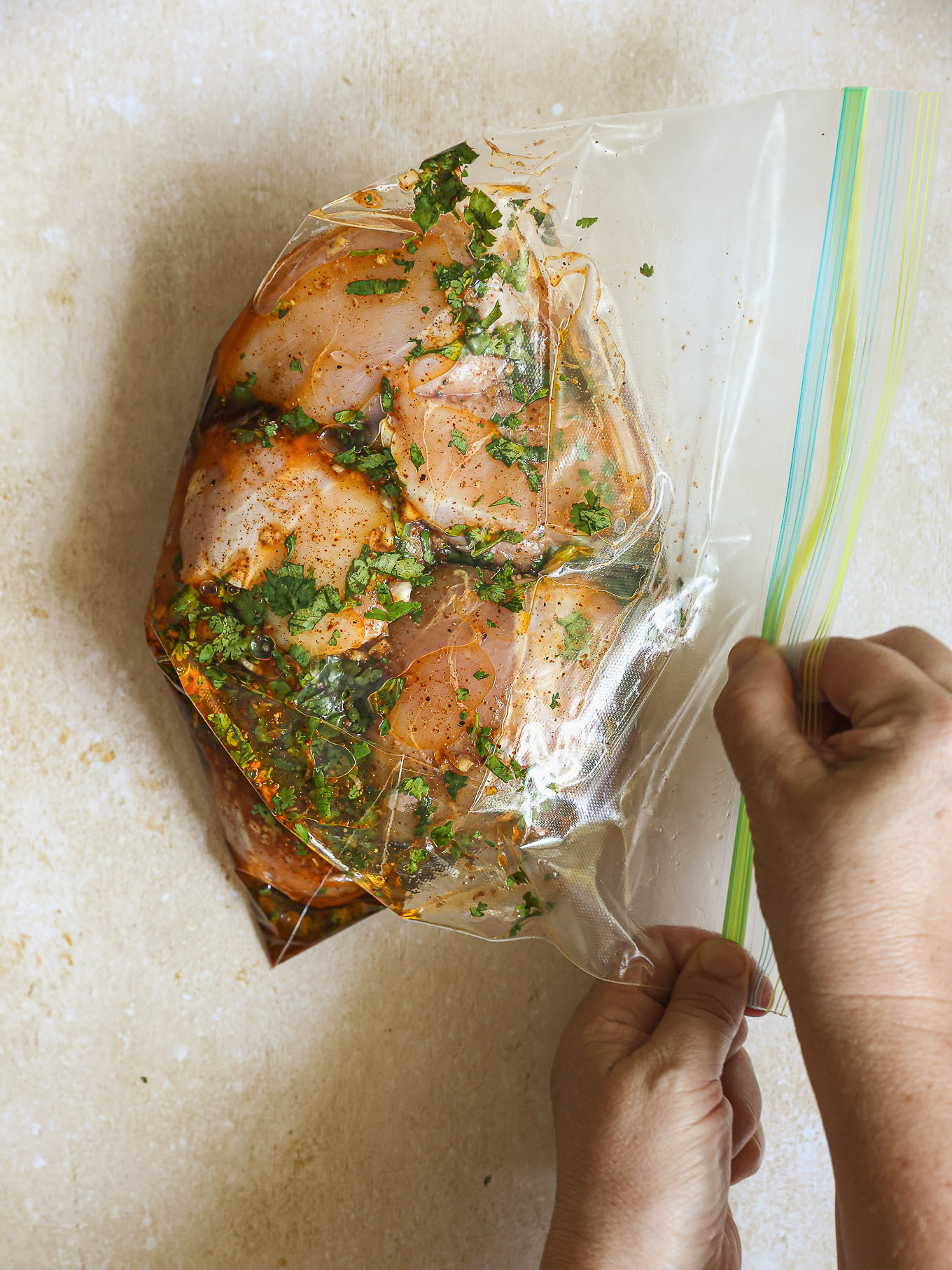 closed ziploc bag with raw chicken.