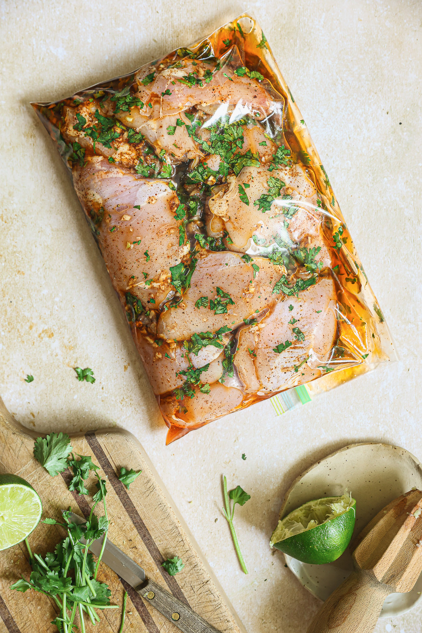 chicken marinaded inside a ziploc bag.