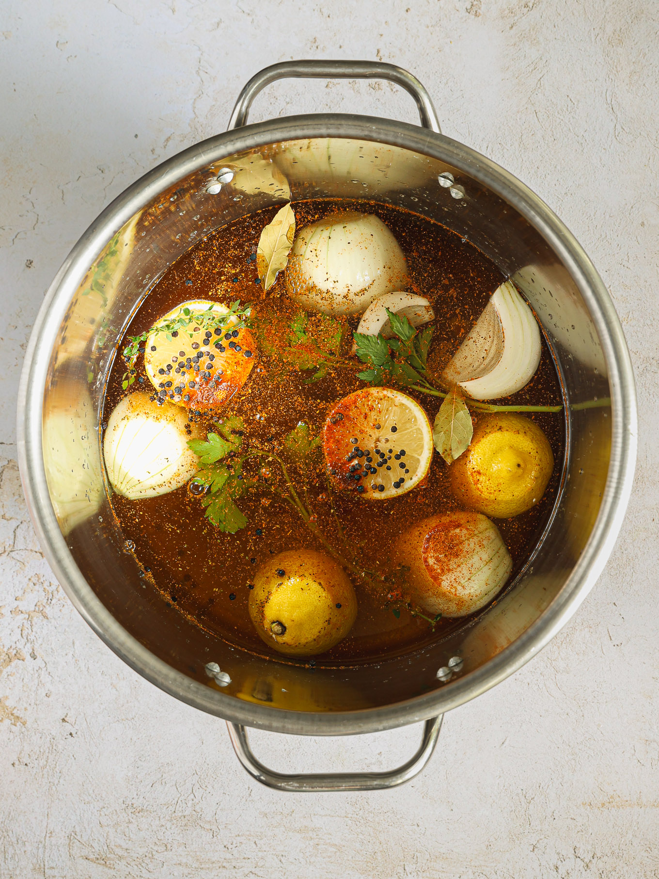 onions and lemons in broth with spices.