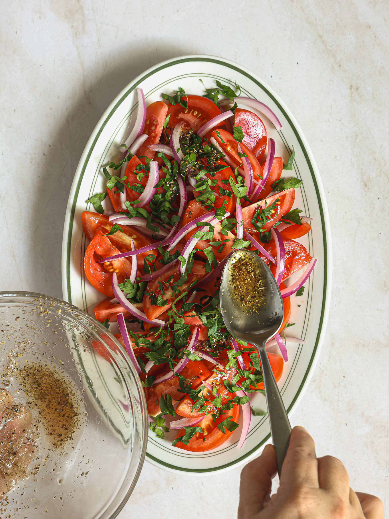 dressing spooned over tomato salad.