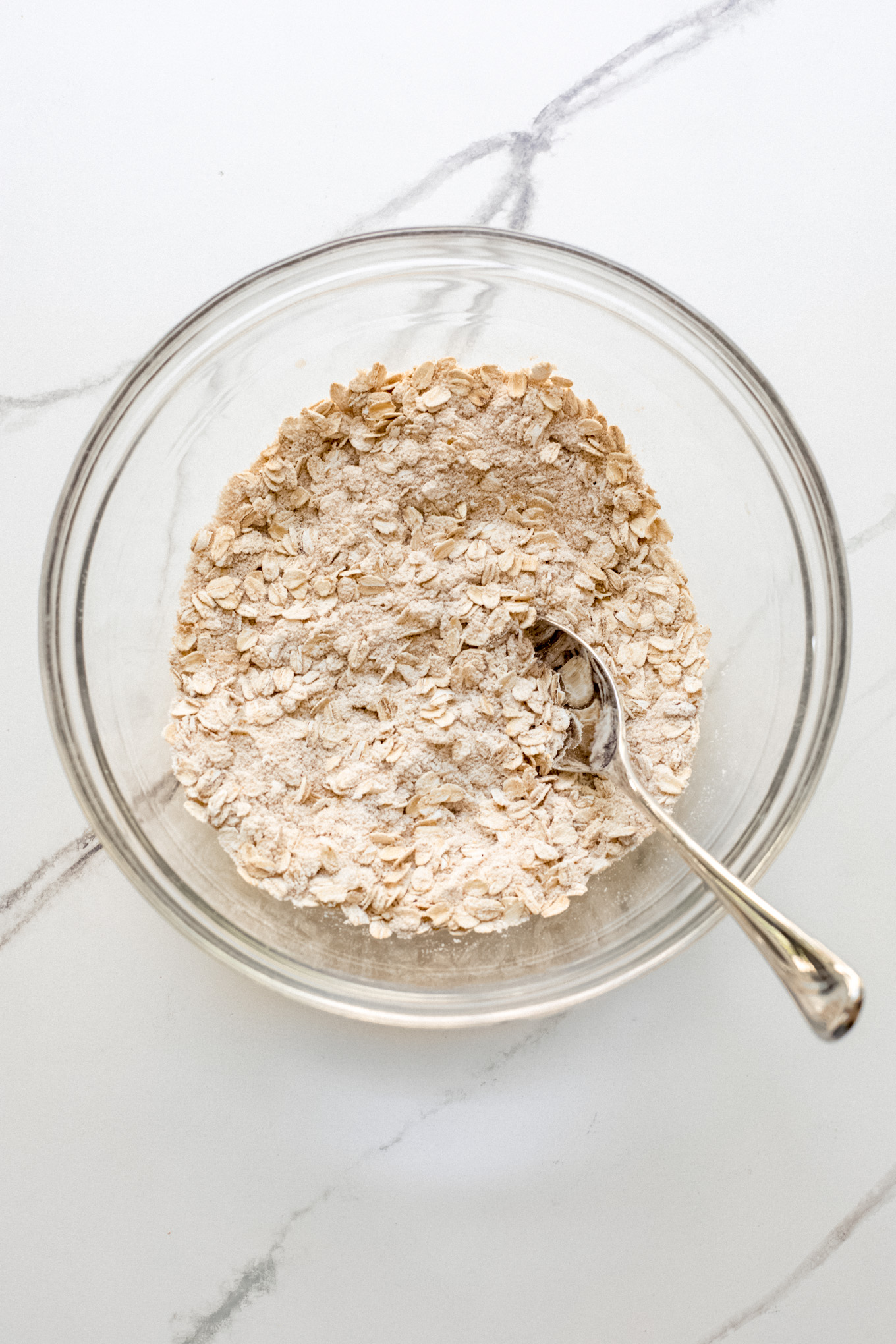 oats with flour and sugar in a glass bowl.