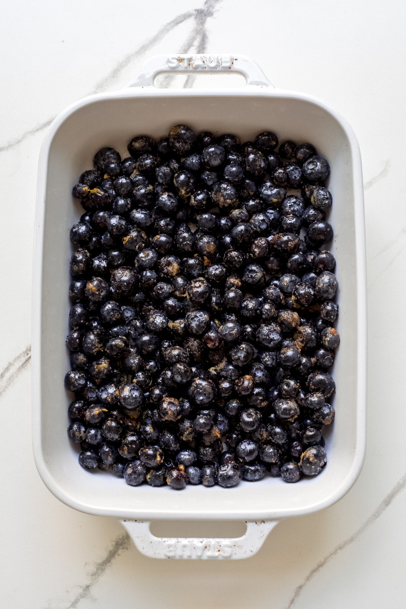 fresh blueberries inside a white baking dish.