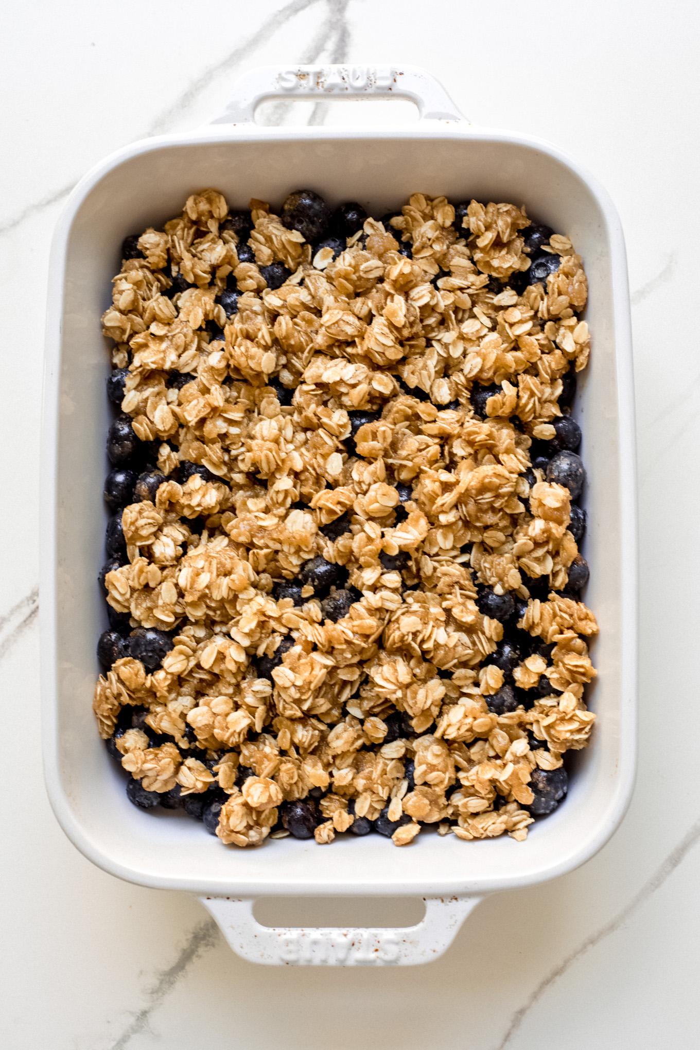 blueberries topped with oat and flour crumble topping.