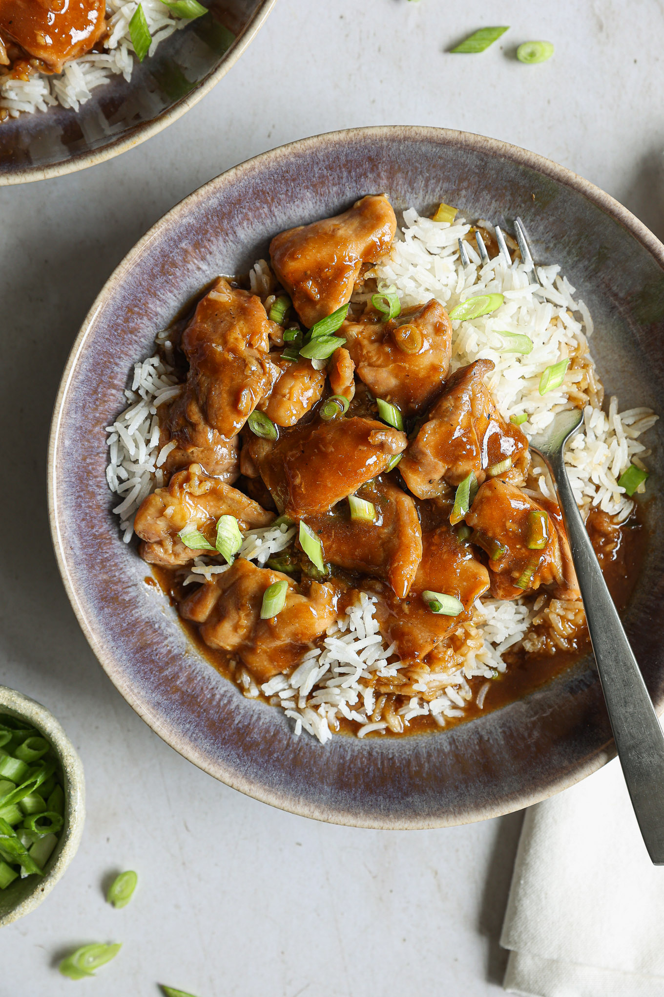 cooked chicken in homemade teriyaki sauce in a bowl over rice.