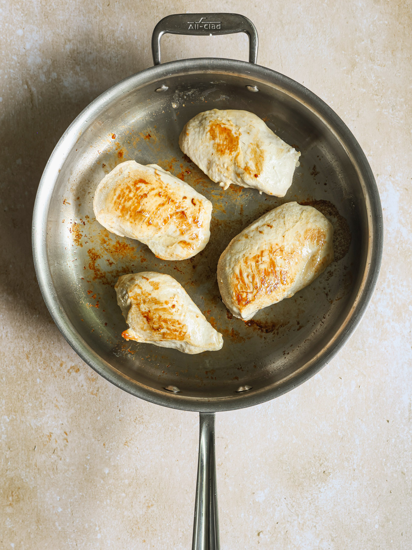 seared chicken breast in a pan.