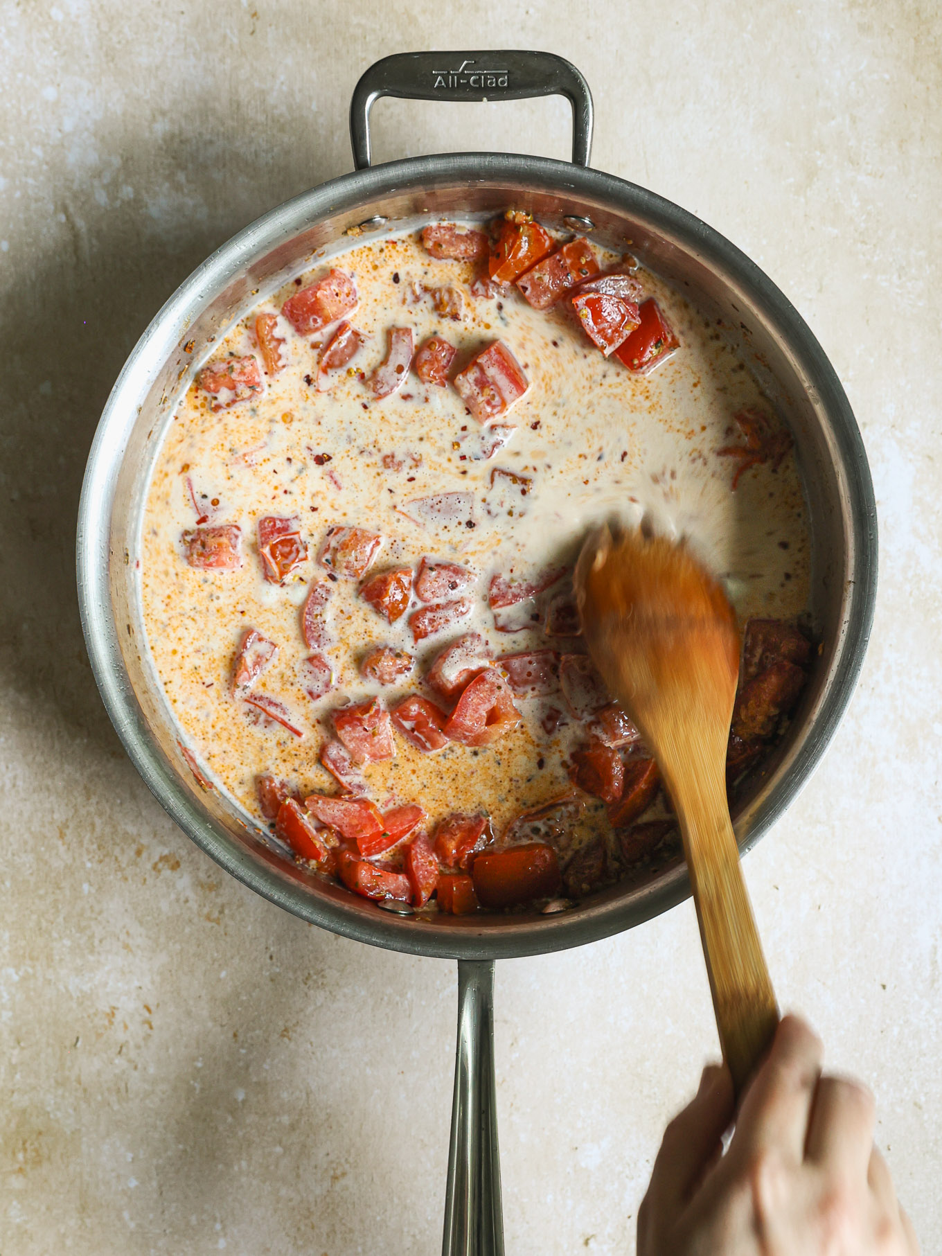 diced tomatoes in cream in a saute pan.