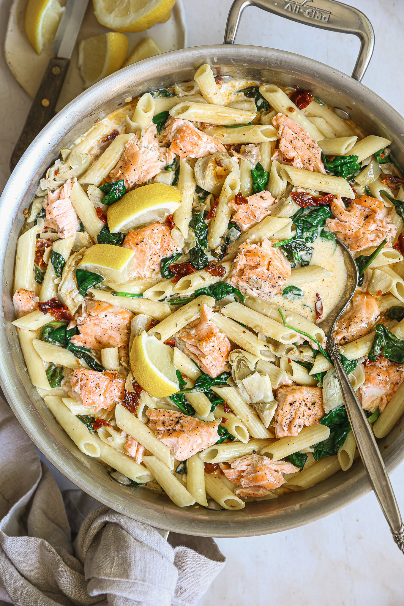 salmon pasta with spinach and sun-dried tomatoes.