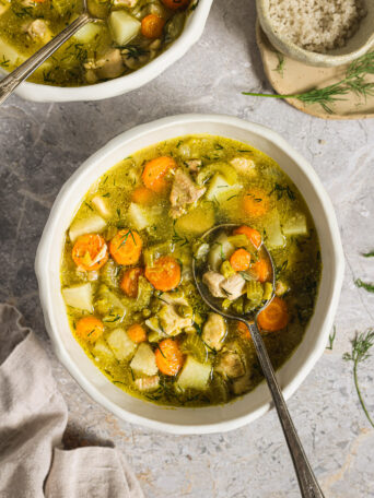 green split pea soup garnished with dill.