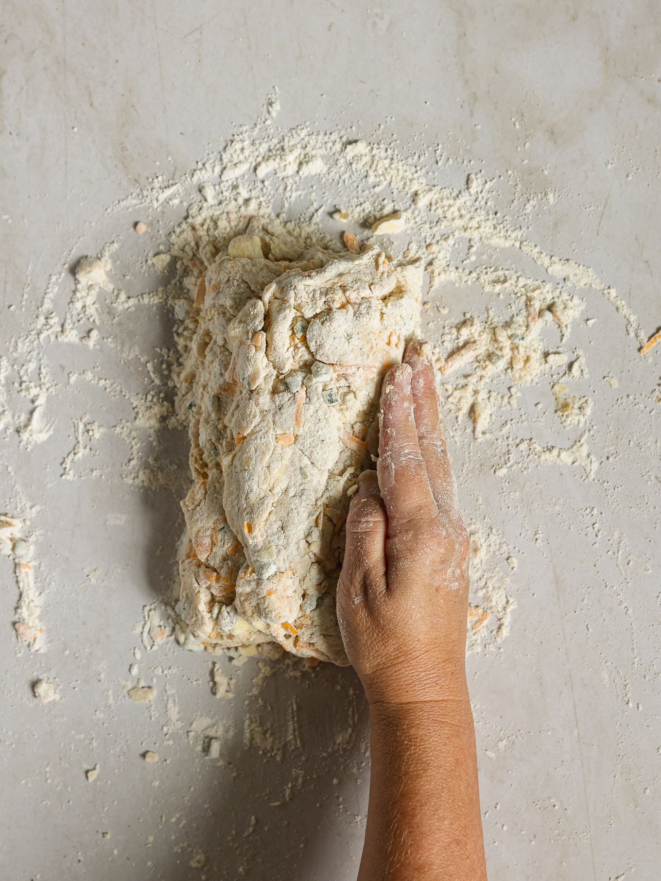 dough rolled up on floured surface.