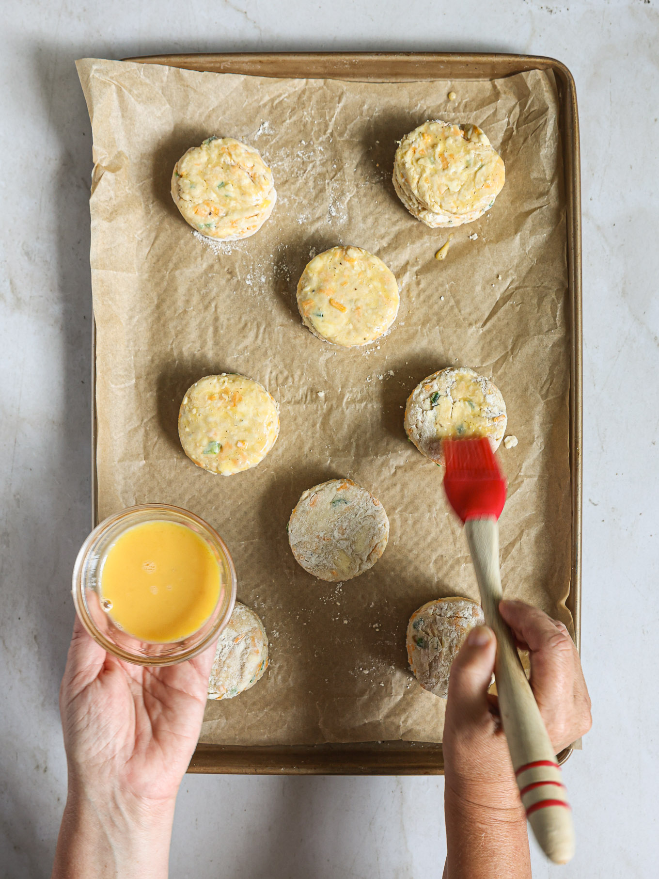 biscuits on baking sheet brushed with egg wash.