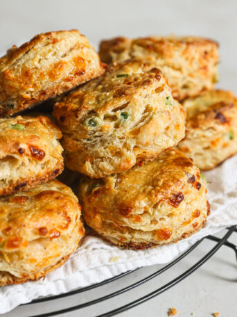 jalepno cheddar biscuits stacked in a bowl.