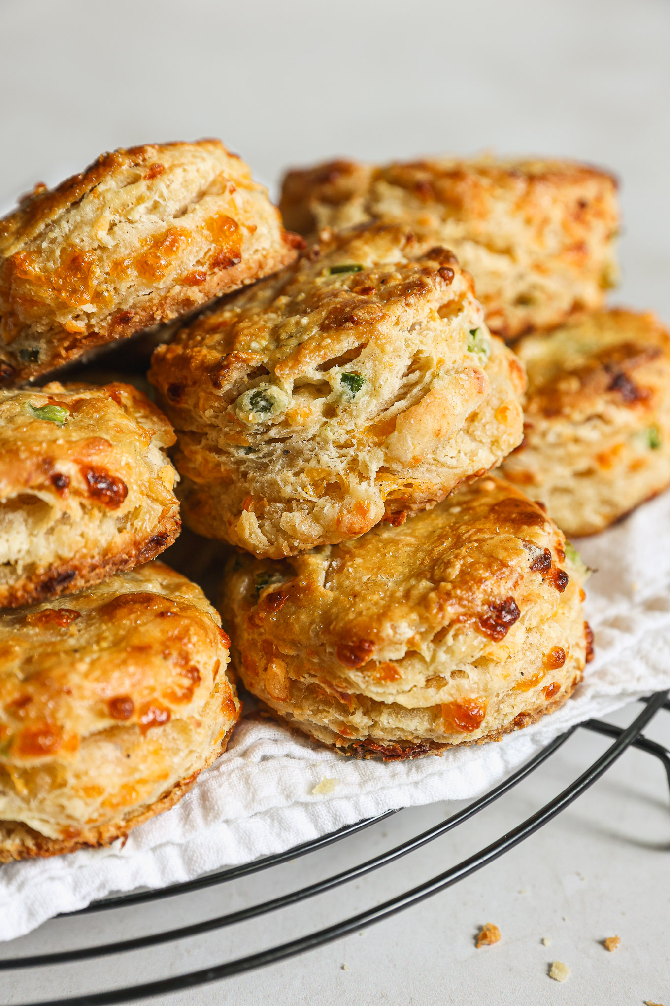 jalapeno cheddar biscuits stacked in a bowl.