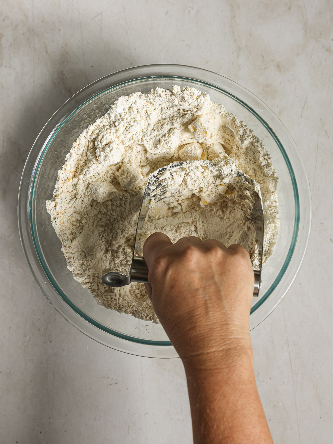 butter being cut into flour.