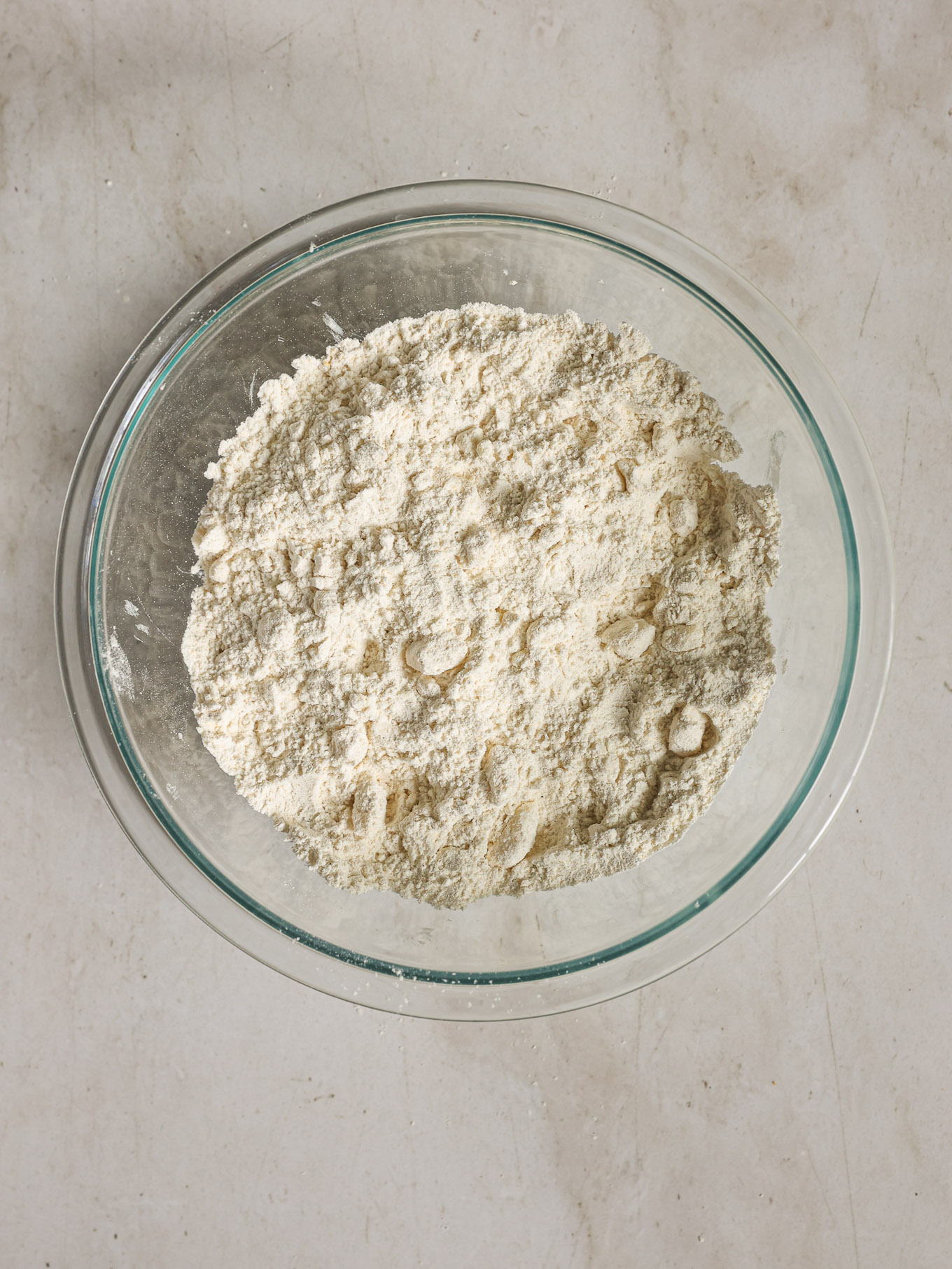 flour with butter in a glass bowl.