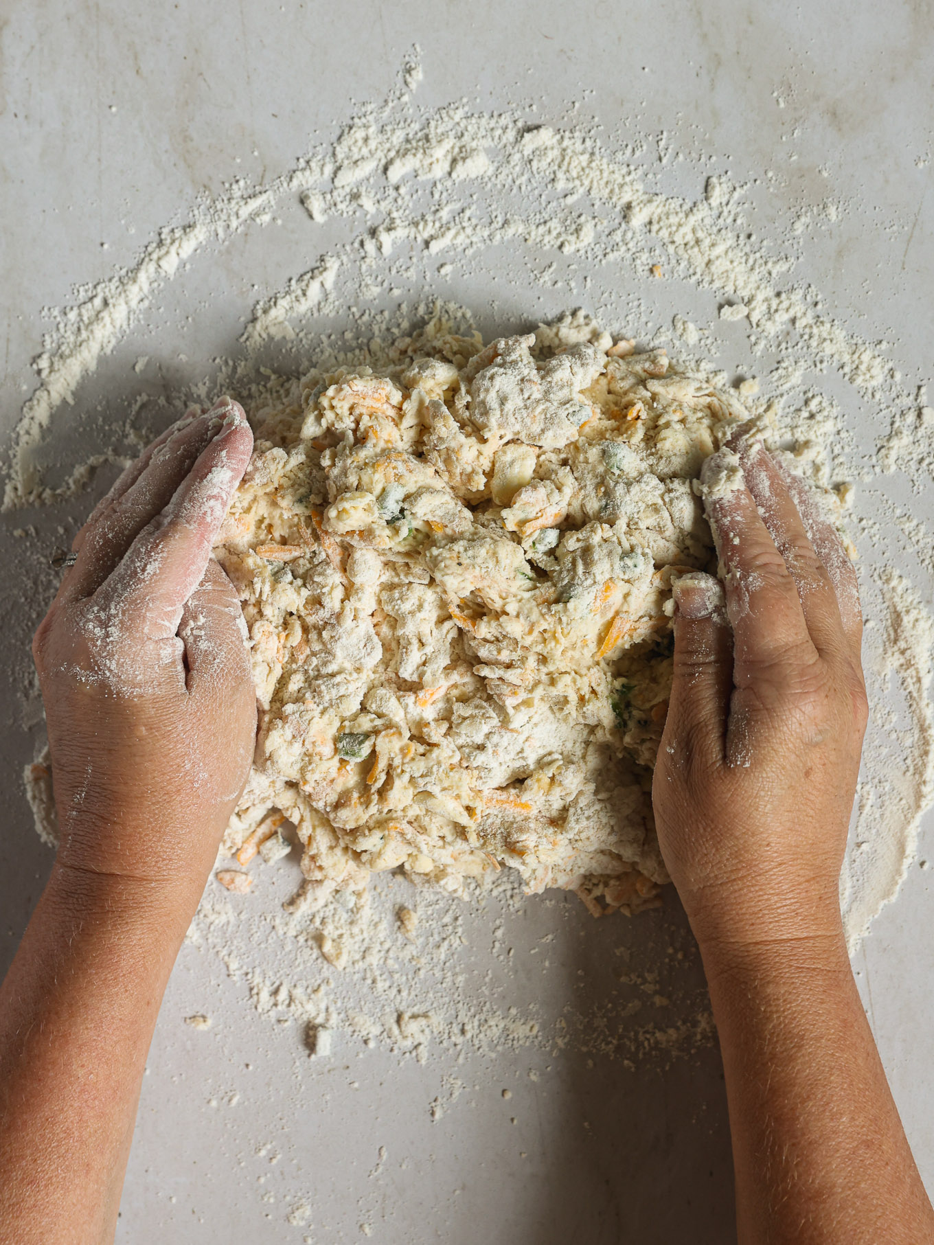 dough on floured surface being kneaded.