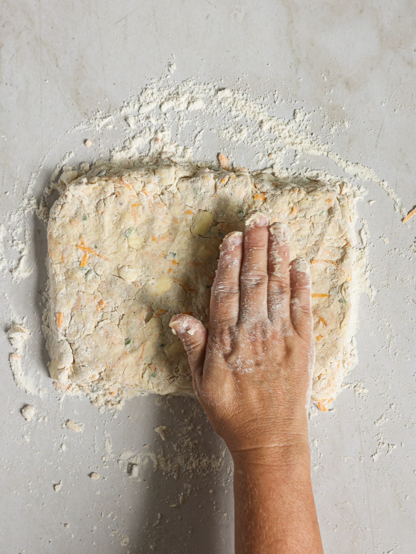 biscuit dough rolled out on surface.